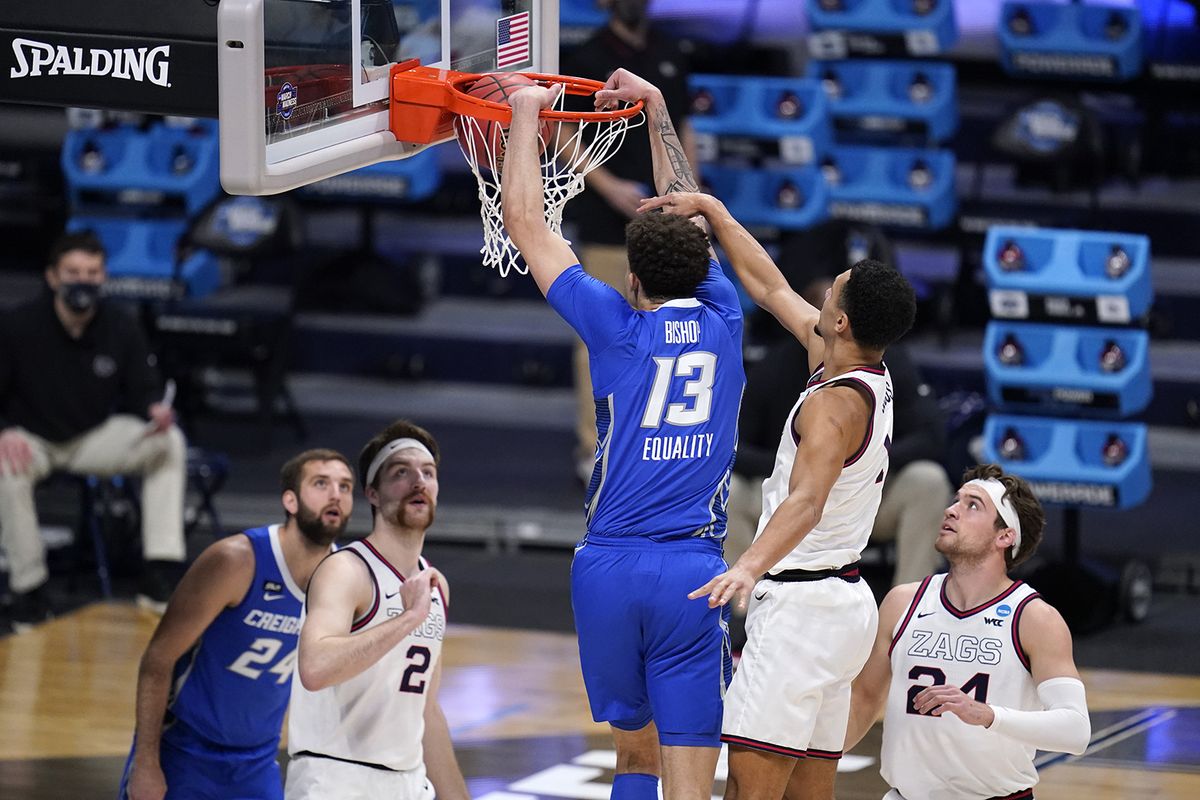 Creighton forward Christian Bishop (13) dunks on Gonzaga guard Jalen Suggs (1) in the first half of a Sweet 16 game in the NCAA men