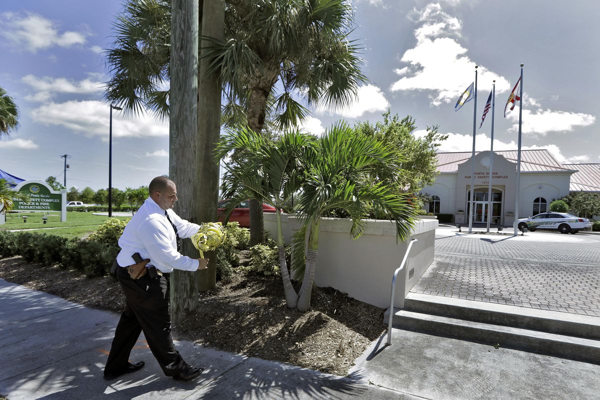 Punta Gorda Police Dept. Det. J. Davoult takes down crime scene tape outside Public Safety Complex Wednesday, Aug. 10, 2016, in Punta Gorda, Fla. Police say an officer accidentally shot a woman to death during a citizen’s academy “shoot/don’t shoot” exercise Tuesday evening. (Chris O’Meara / Associated Press)