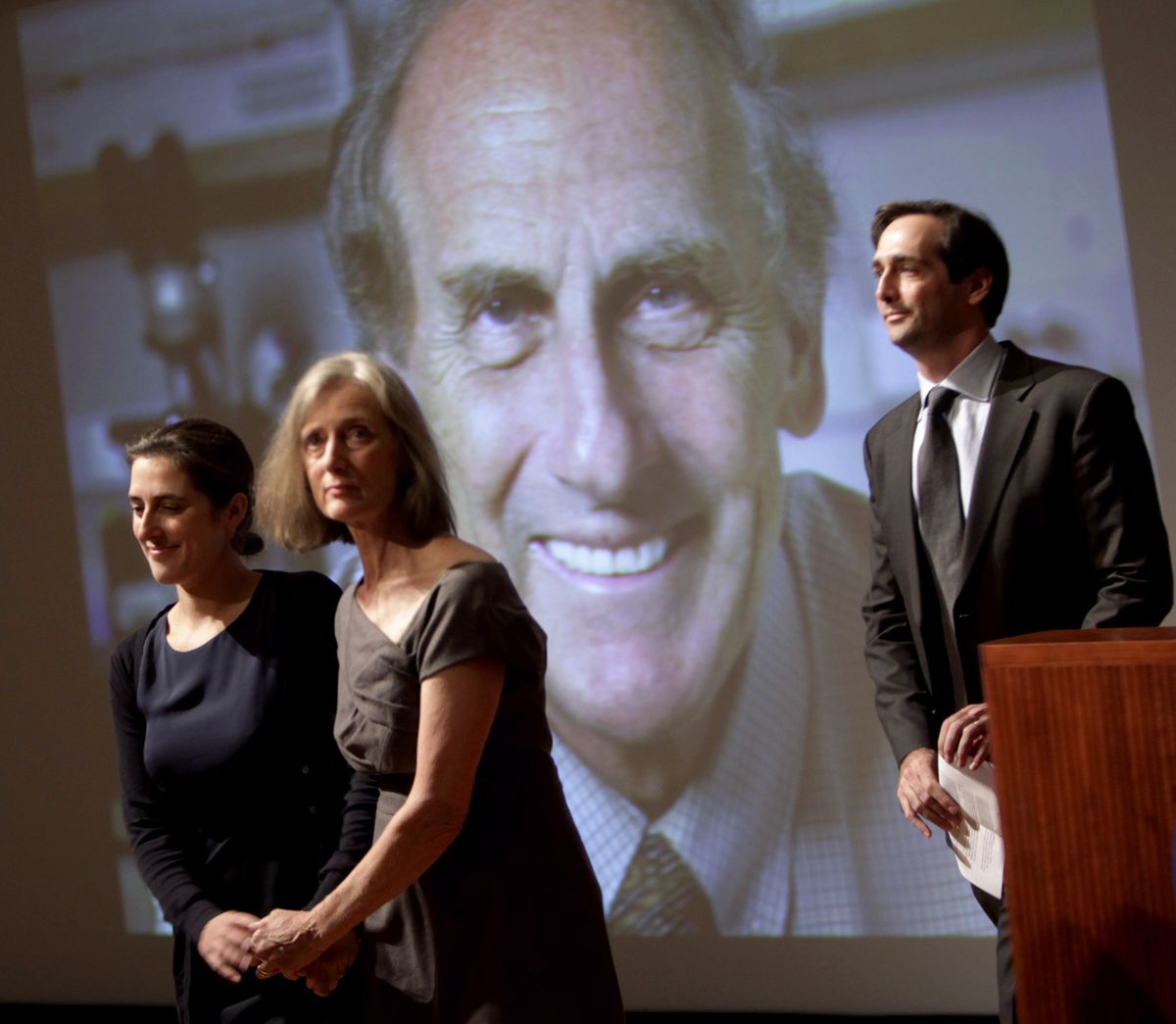 Family members of Nobel prize winner Ralph Steinman walk in front of a picture of Steinman during a ceremony honoring him at Rockefeller University in New York, Monday, Oct. 3, 2011. From left to right are daughter Lesley Steinman, wife Claudia Steinman and son Adam Steinman. Canadian-born Ralph Steinman, a cell biologist, was awarded the Nobel Prize in medicine on Monday for his discoveries about the immune system, but hours later his university said that he had died three days earlier. The Nobel committee had been unaware of his death. (Seth Wenig / Associated Press)