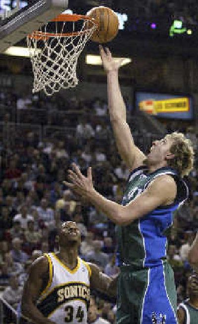 Ray Allen can only watch as Dirk Nowitzki tips in two of his 34 points for Dallas.
(Associated Press / The Spokesman-Review)