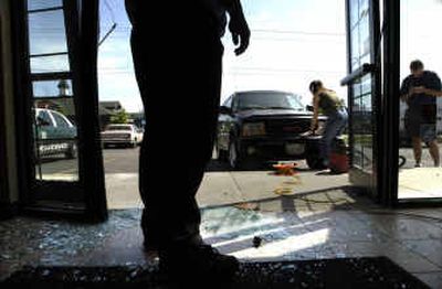 Tatiana Sinyavskaya, 30, the driver of a borrowed black GMC Envoy, pictured, jumped the curb while parking and crashed through the double glass doors of the Washington Mutual Branch at 3007 E. 57th on Wednesday. No one was injured. Tatiana Sinyavskaya, 30, the driver of a borrowed black GMC Envoy, pictured, jumped the curb while parking and crashed through the double glass doors of the Washington Mutual Branch at 3007 E. 57th on Wednesday. No one was injured.
(Jed Conklin/Jed Conklin/ / The Spokesman-Review)