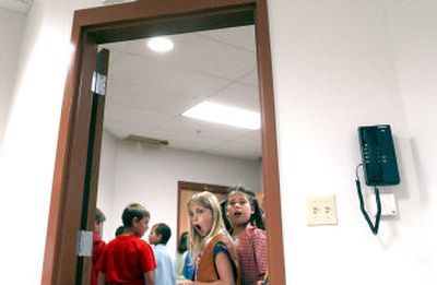 
Ashleigh Jenkins, left, and Rachael Mylroie, third-graders from Hayden Lake Elementary, take a peek into the new teachers' lounge at Atlas Elementary during a tour of the new school on Tuesday. 
 (Kathy Plonka / The Spokesman-Review)