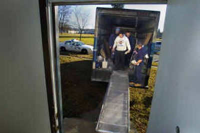 
Curt Hubbard, in white, and the rest of the DeVries Moving crew take a break Monday while moving the West Central COPS Shop to a new locale. 
 (Christopher Anderson/ / The Spokesman-Review)