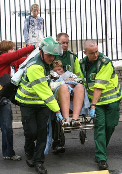 
Paramedics help a boy after Thursday's accident. Associated Press
 (Associated Press / The Spokesman-Review)