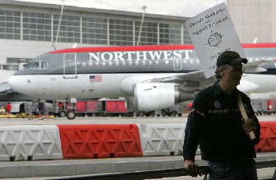 
Northwest Airlines striking mechanic Dave Kukic pickets outside the McNamara terminal as a flight departs Detroit Metropolitan Airport in Romulus, Mich., Tuesday. About 4,400 Northwest unionized mechanics, cleaners and custodians walked off the job Saturday.
 (Associated Press / The Spokesman-Review)