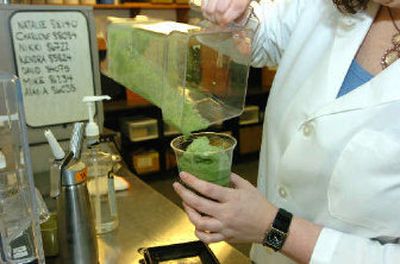 
 Starbucks researcher Jessica Gurry pours a freshly blended Tazo green tea Frappuccino at Starbucks headquarters.  
 (The Spokesman-Review)