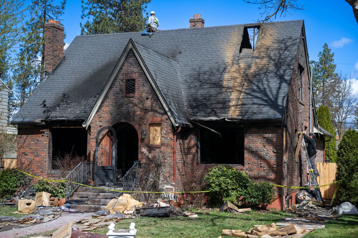A woman and her two dogs died early Wednesday in a house fire at 608 W. 27th Ave. on the South Hill. (COLIN MULVANY)