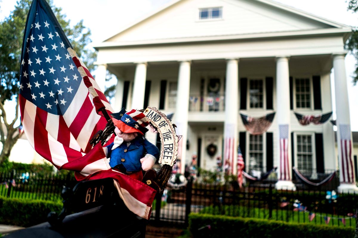 American flags decorate a home in Celebration in 2019. MUST CREDIT: Washington Post photo by Melina Mara.  (Melina Mara/The Washington Post)