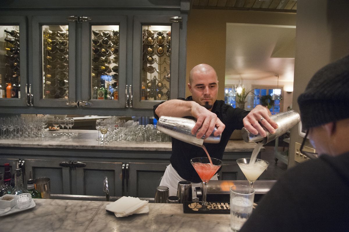Patrick Kasper mixes his “Patrick Passion” cocktail for a Luna Restaurant customer last week in Spokane. He has worked in the bar for the past six years. Longtime restaurateur Marcia Bond and her husband, William, are selling their beloved Luna Restaurant on the South Hill to a local family, who will operate it in the same hands-on manner as the Bonds. (Dan Pelle)