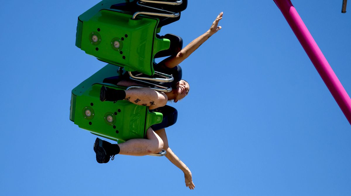 Stephanie McPhail of Rathdrum raises her arms Sunday while riding on The Freak Out at the North Idaho State Fair in Coeur d’Alene.  (Kathy Plonka/The Spokesman-Review)