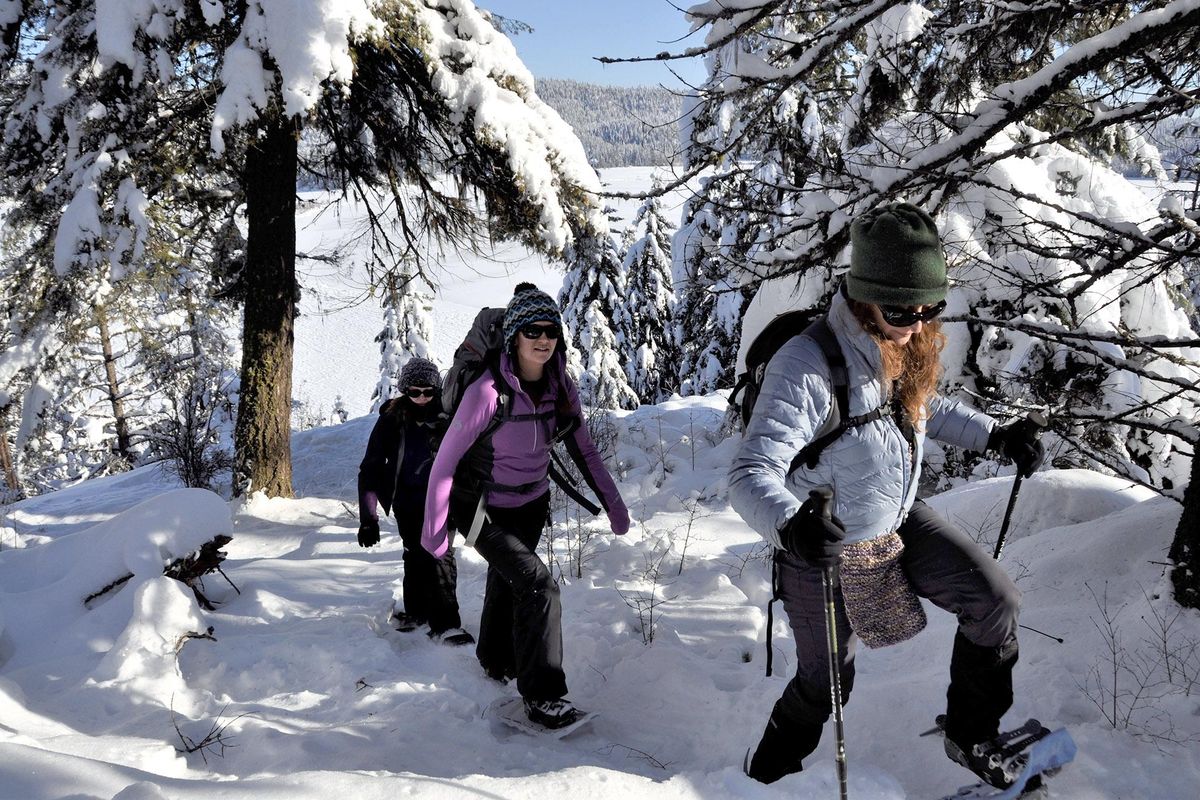 Margaret Bowers, right, and Holly Weiler join a snowshoeing group exploring the McKenzie Conservation Area above Newman Lake. (Rich Landers / The Spokesman-Review)
