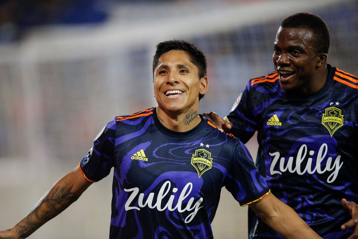 Seattle Sounders forward Raul Ruidiaz (9) celebrates his goal with defender Nouhou Tolo (5) during the first half against New York City FC in the second leg of a CONCACAF Champions League soccer semifinal, Wednesday, April 13, 2022, in Harrison, N.J.  (Eduardo Munoz Alvarez)
