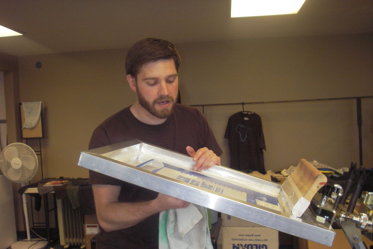 Scott Ellis works on a silk screen at Blue Button Apparel in Hillyard. His company works with at-risk students by providing jobs, meals after shifts, rides to and from work, and needed mentorship.  (Virginia De Leon / Down to Earth NW Correspondent)