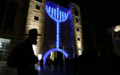 
An ultra-Orthodox Jewish man walks past a large menorah Tuesday at the city hall in Jerusalem. Associated Press
 (Associated Press / The Spokesman-Review)