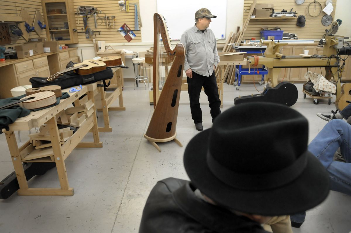 Alan Mikoleit shows off his harp made from bubinga wood as Mike Ryan, foreground, listens during the Feb. 25  Inland Northwest Luthiers Association show-and-tell meeting.  (Photos by Christopher Anderson / The Spokesman-Review)