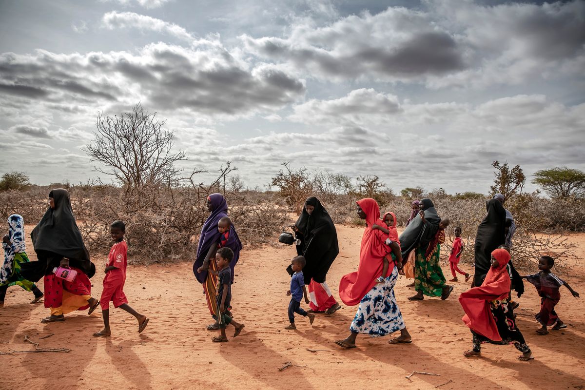 A group of several displaced families on their way to a camp in a remote area around six miles from Doolow, Somalia, on June 15.  (Luis Tato/For The Washington Post)