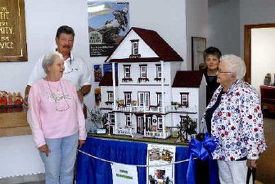 
From left, Judy and Wes Krueger, Sharon Moore and Priscilla Spivey are part of a group who are raffling off this elaborate doll house full of miniatures to raise money for a new K-9 bomb dog. 
 (Jesse Tinsley / The Spokesman-Review)