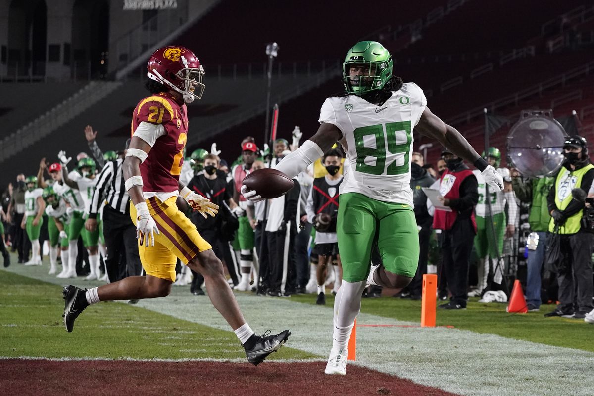 Oregon’s DJ Johnson, right, runs to the end zone for a touchdown against Southern California’s Isaiah Pola-Mao during NCAA college football action Friday.  (Associated Press)