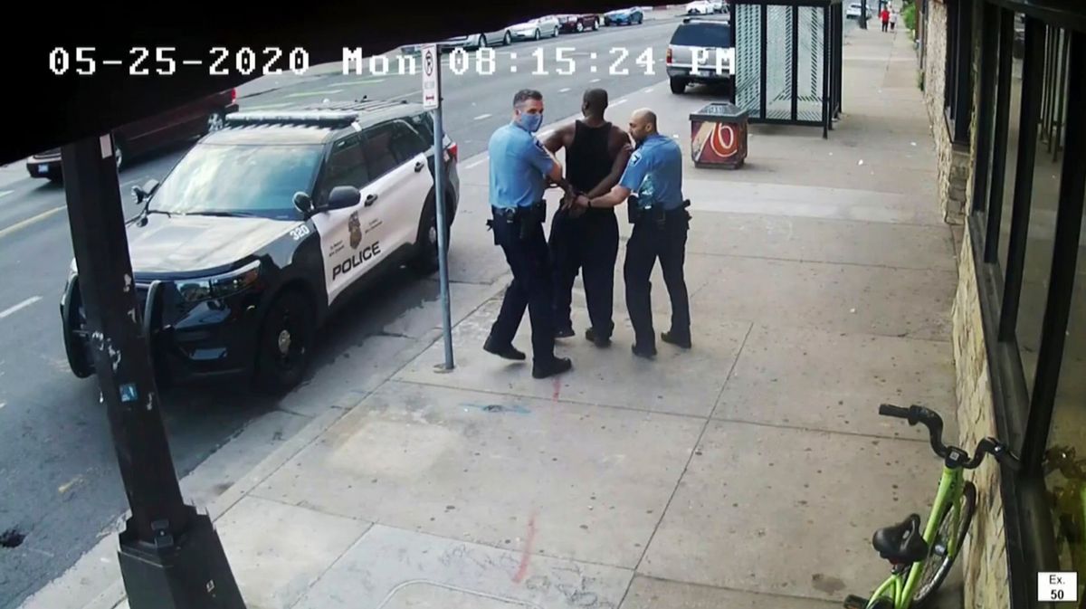 This image from video shows Minneapolis police Officers Thomas Lane, left and J. Alexander Kueng, right, escorting George Floyd, center, to a police vehicle outside Cup Foods in Minneapolis, on May 25, 2020. Three former Minneapolis officers headed to trial this week on federal civil rights charges in the death of George Floyd aren