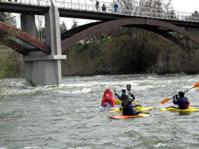 
Kayakers play in the Spokane River during high April flows near the Sandifur Bridge where a white-water park is planned. 
 (File / The Spokesman-Review)