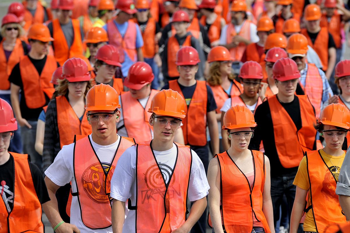 High school and middle school students head out to try their hand on heavy equipment during Construction Career Day at the Spokane County Fair and Expo Center. (Dan Pelle)