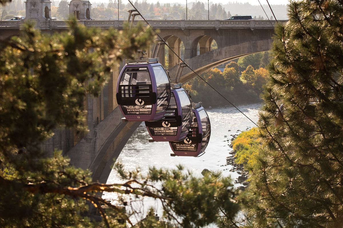 The Numerica SkyRide passes between changing trees along the Spokane River near Riverfront Park, as seen during golden hour on Oct. 6, 2020 in downtown Spokane, Wash. There are many vantage points for observing the autumnal changes in one of Spokane