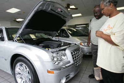 
Arthur and Earlene Kimble look at a 2005 Chrysler 300 on the showroom floor at River Oaks Chrysler-Jeep dealership Friday in Houston. 
 (Associated Press / The Spokesman-Review)