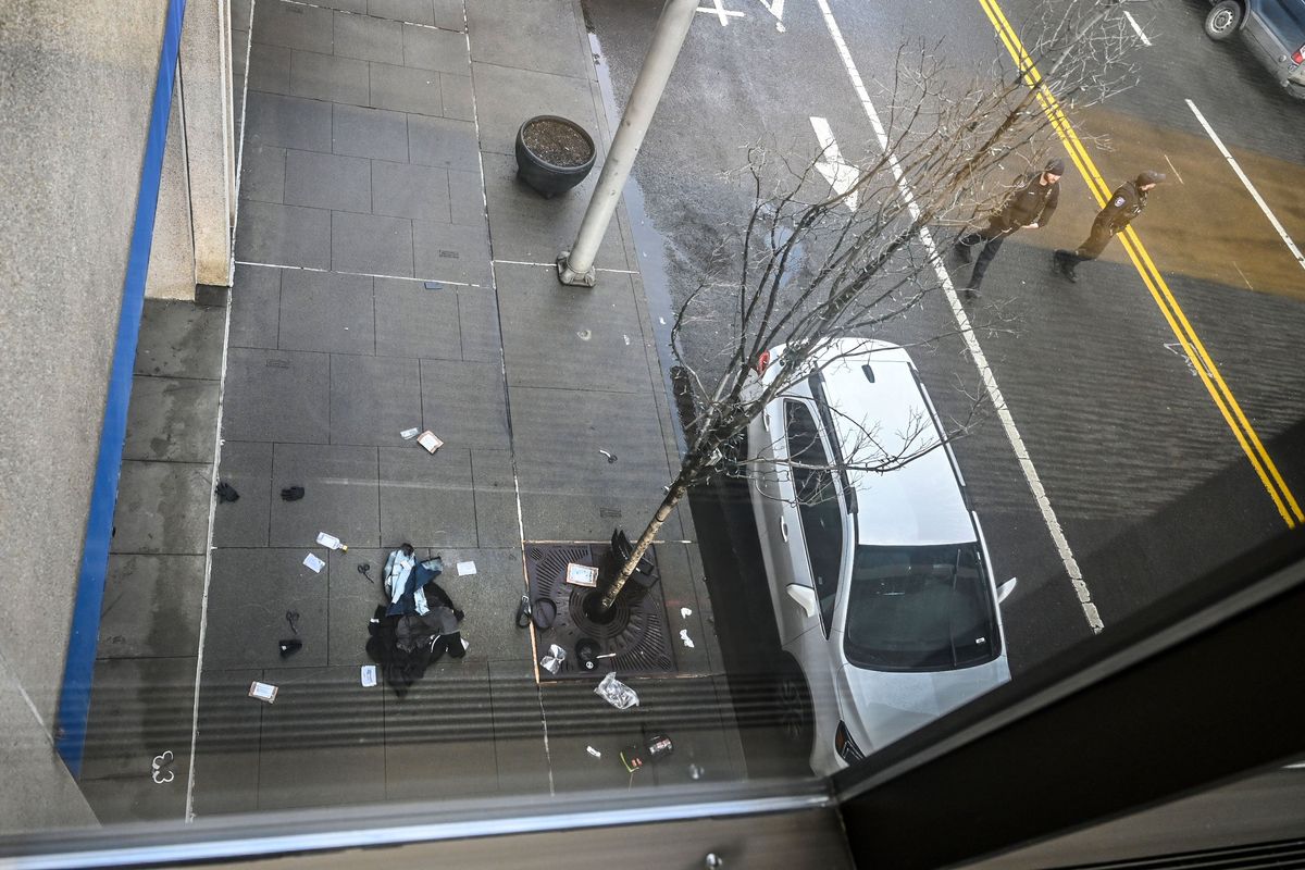 Items are left on the ground at the scene of police shooting on Howard Street, Monday, Feb. 12, 2024, in downtown Spokane.  (DAN PELLE/THE SPOKESMAN-REVIEW)