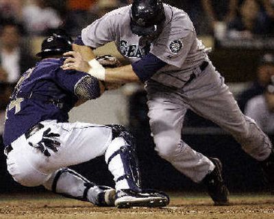 
Richie Sexson knocks over Rob Bowen, but he is still out in ninth. 
 (Associated Press / The Spokesman-Review)