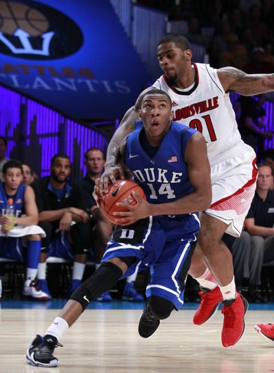 Duke guard Rasheed Sulaimon (14) is fouled by Louisville forward Chane Behanan (21) in the second half of the Blue Devils’ win. (Associated Press)