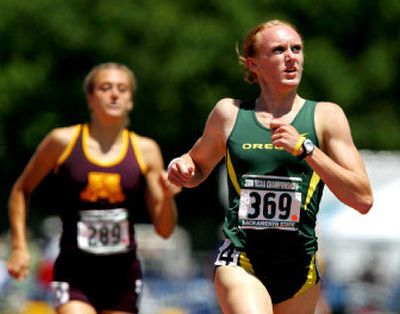 
Oregon's Rebekah Noble, right, looks to the video screen to see her time as she crosses the finish line to win the women's 800 meters at the NCAA championships.
 (Associated Press / The Spokesman-Review)