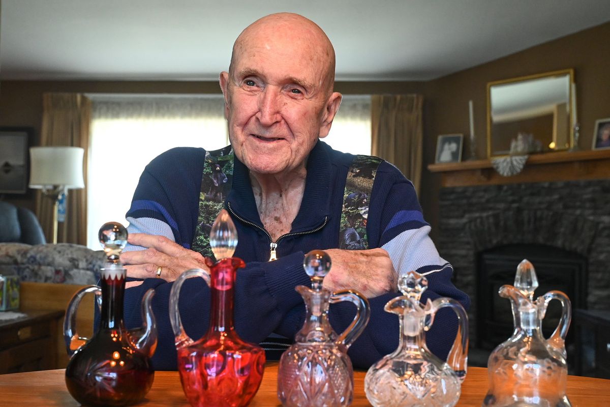 Dick Redinger, of Chattaroy, has been collecting cruets for 50 years. He has 105 of them on display in a cabinet he made.  (DAN PELLE/THE SPOKESMAN-REVIEW)