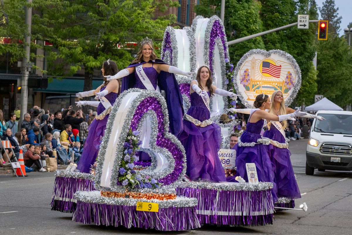 The Lilac Festival Royal Court greets spectators from their float during the Lilac Festival’s Armed Forces Torchlight Parade, in downtown Spokane, Sat. May 17, 2025. (COLIN MULVANY)