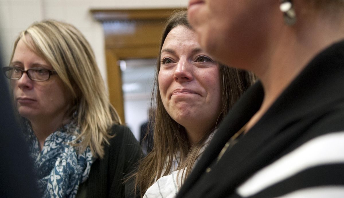 Lindy Moore, center, talks with friends and family at the Kootenai County Courthouse on Friday, Oct. 13, 2017, after a jury found Jonathan Renfro guilty of first-degree murder for killing of her husband Sgt. Greg Moore. (Kathy Plonka / The Spokesman-Review)