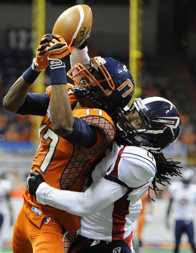 Shock receiver Adron Tennell, left, catches TD pass over Rush defender Vic Hall. (Tyler Tjomsland)
