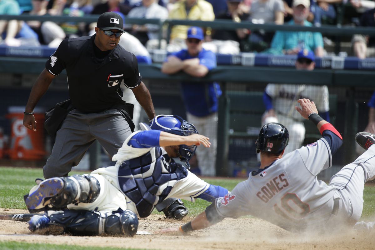 Indians’ Yan Gomes is out at home on a tag by Welington Castillo after Gomes tried to score on a grounder in the sixth. (Associated Press)