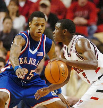 
Texas Tech's Martin Zeno dribbles in front of Kansas' Brandon Rush during the second half. 
 (Associated Press / The Spokesman-Review)
