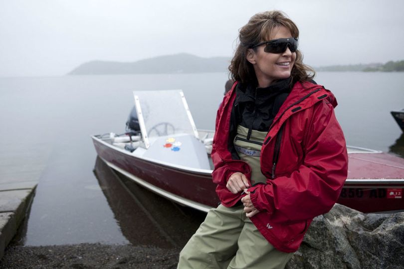 Sarah Palin sits next her husband Todd's boat in Dillingham, Alaska, in July 2010 as part of a documentary for the TLC channel.  (Associated Press)