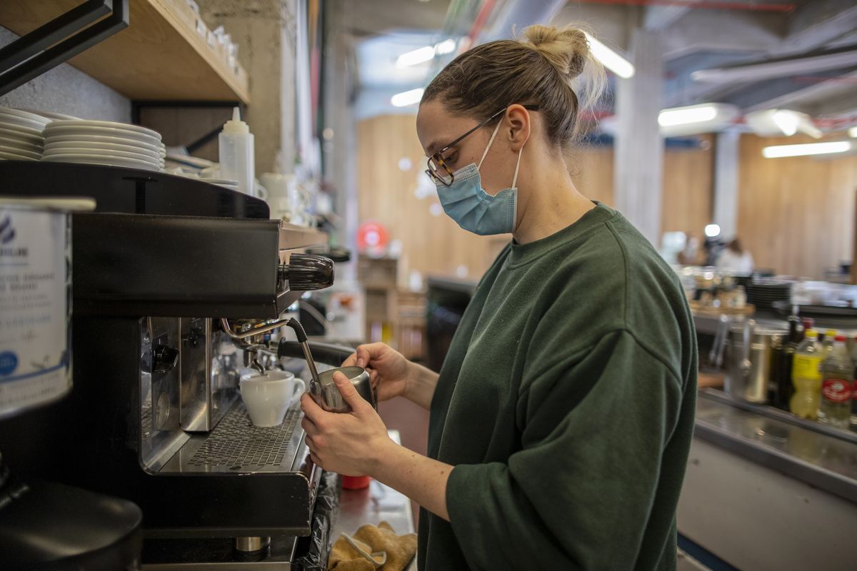 Waiter Sara Palacios prepares a coffee as she works at La Francachela restaurant Friday in Madrid, Spain. (Manu Fernandez)