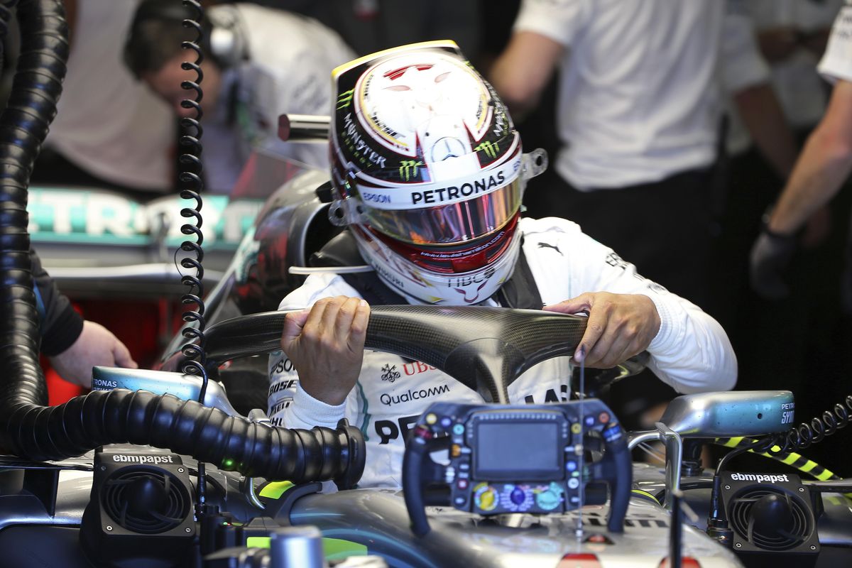 Mercedes driver Lewis Hamilton of Britain struggles to get our of his car at the end of the first practice session at the Australian Formula One Grand Prix in Melbourne, Friday, March 23, 2018. The first race of the 2018 seasons is on Sunday. (Rick Rycroft / Associated Press)