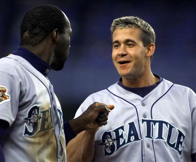 Seattle shortstop Mark McLemore, left, congratulates Bret Boone on one of his three hits that drove in five runs in Seattle's 14-3 victory over the New York Yankees in Game 3 of the American League championship series, Saturday, October 20, 2001.   (Tribune News Service)