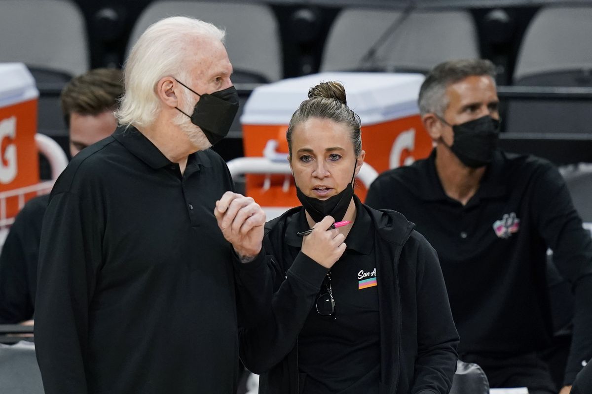 FILE - San Antonio Spurs head coach Gregg Popovich, left, talks with assistant coach Becky Hammon during the second half of an NBA basketball game against the Orlando Magic in San Antonio, in this Friday, March 12, 2021, file photo. Hammon can