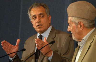 
U.S. Ambassador Zalmay Khalilzad, left, talks to reporters alongside prominent Sunni leader Adnan al-Dulaimi during a news conference in Baghdad Tuesday. The ambassador suggested there may be further changes to the draft constitution in order to win Sunni Arab approval. 
 (Associated Press / The Spokesman-Review)