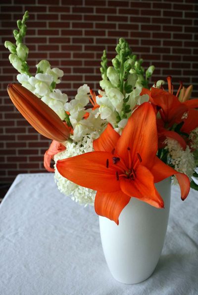 To mimic orange and off-white, a hot color combination on the runways, one option is to combine orange Asiatic lilies with off-white snapdragons and hydrangeas. Special to  (Megan Cooley Special to / The Spokesman-Review)