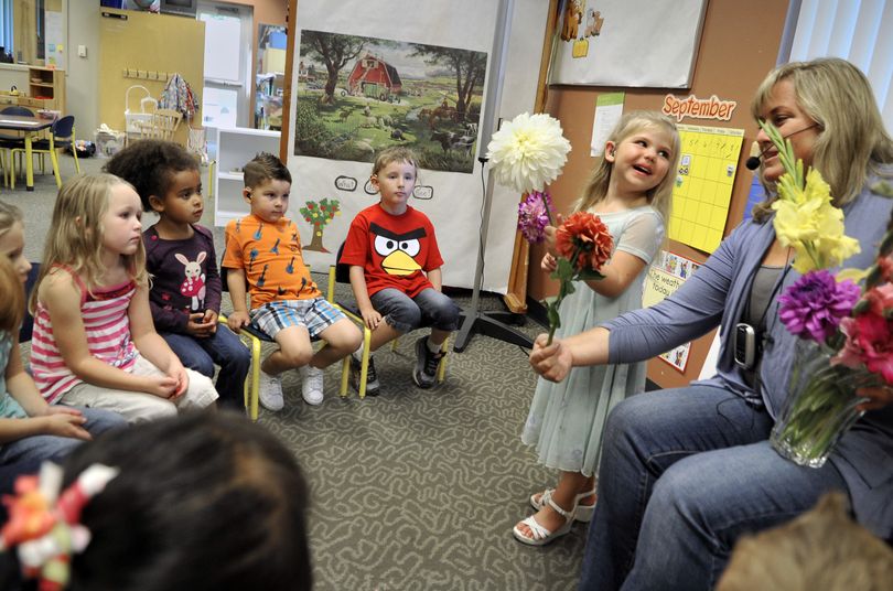 Payton Miller shows teacher Amy Hardie and her classmates the flowers she brought to the HOPE School on Sept. 13 on the Riverpoint Campus in Spokane. (Dan Pelle)