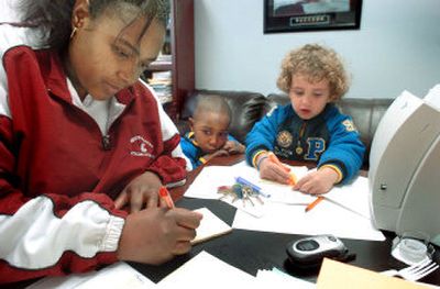 
DaVina Hoyt works at her office in Washington State University's Compton Union Building recently as her 3-year-old son, Caleb Berry, center, and Anthony Marshal, 4, wait to go swimming. 
 (Joe Barrentine / The Spokesman-Review)