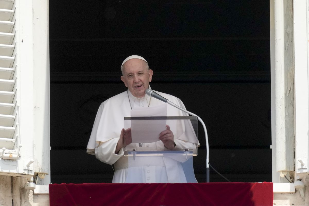 Pope Francis delivers his message during the Angelus noon prayer from the window of his studio overlooking St.Peter