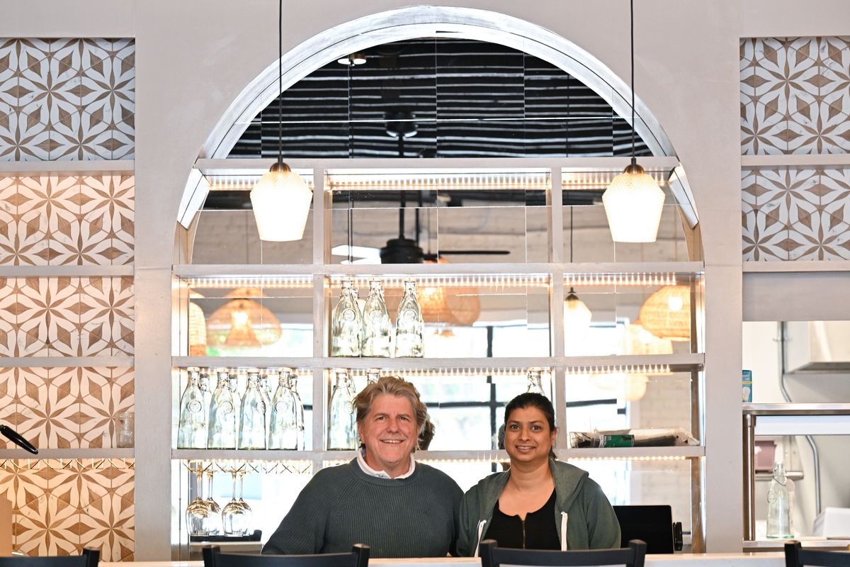 Indicana owners Chip Overstreet and Noreen Hiskey pose for a photo behind the bar of their restaurant on Sept. 19 at 1020 S. Perry St. in Spokane. The Mexican and Indian fusion restaurant officially opened Oct. 22.  (Tyler Tjomsland/The Spokesman-Review)