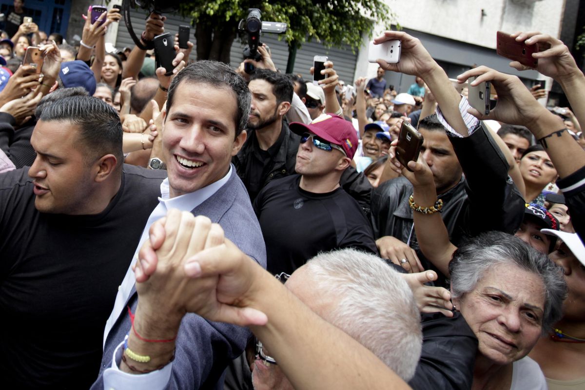 Venezuela’s self-proclaimed interim president Juan Guaido greets supporters at a rally in Los Teques, Miranda State, Venezuela on Saturday. (Boris Vergara / AP)
