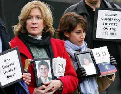 Relatives of two Sept. 11 victims hold photos of their loved ones who died that day as they join a vigil outside the White House on Monday to urge passage of legislation that would revamp the nation's intelligence agencies.
(Associated Press / The Spokesman-Review)